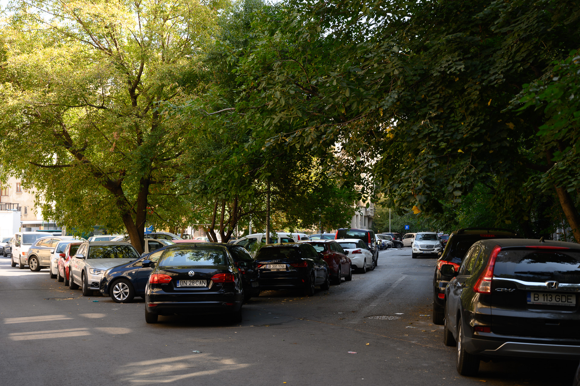 Under communism very few residents could afford or have a car.  There were no car parks/garages.  Now, nearly all have cars.  But still no car parks or garages.